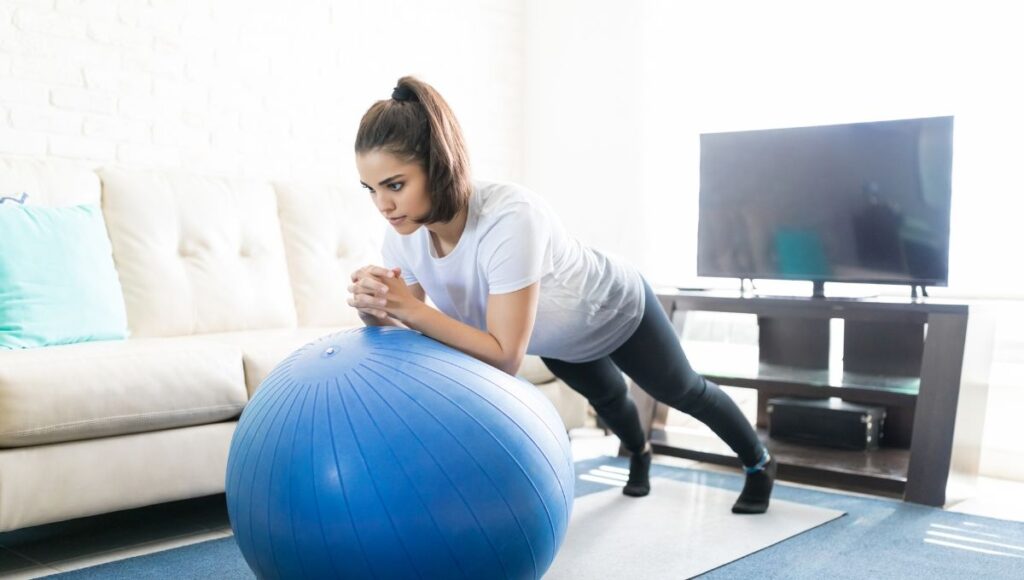 woman doing a swiss ball roll outs